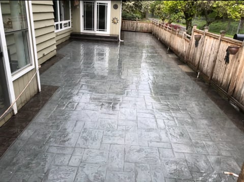 Newly constructed stamped concrete patio with geometric pattern